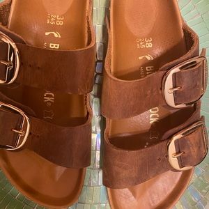 Women’s size 38 gold buckle Birkenstock’s.